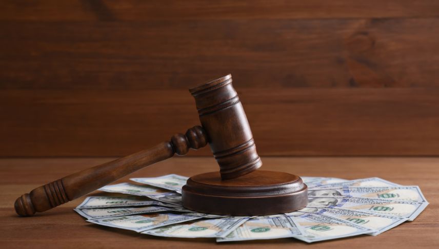 judges gavel and dollar bills on wooden table