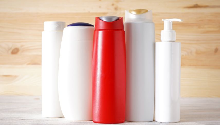 different cosmetic bottles on wooden background