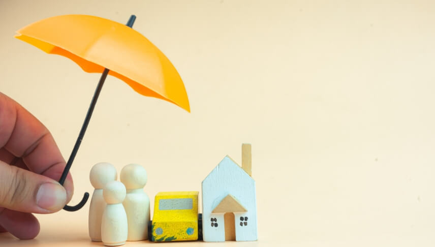 umbrella on miniature people car and house insurance concept