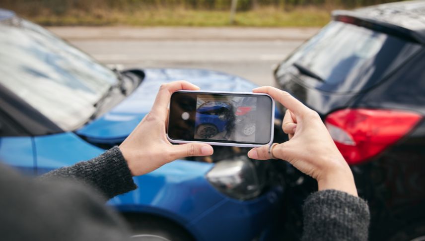 person taking photo of car collision