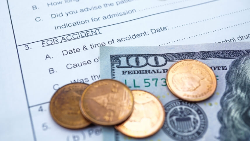 coins and dollar bill on top of a document