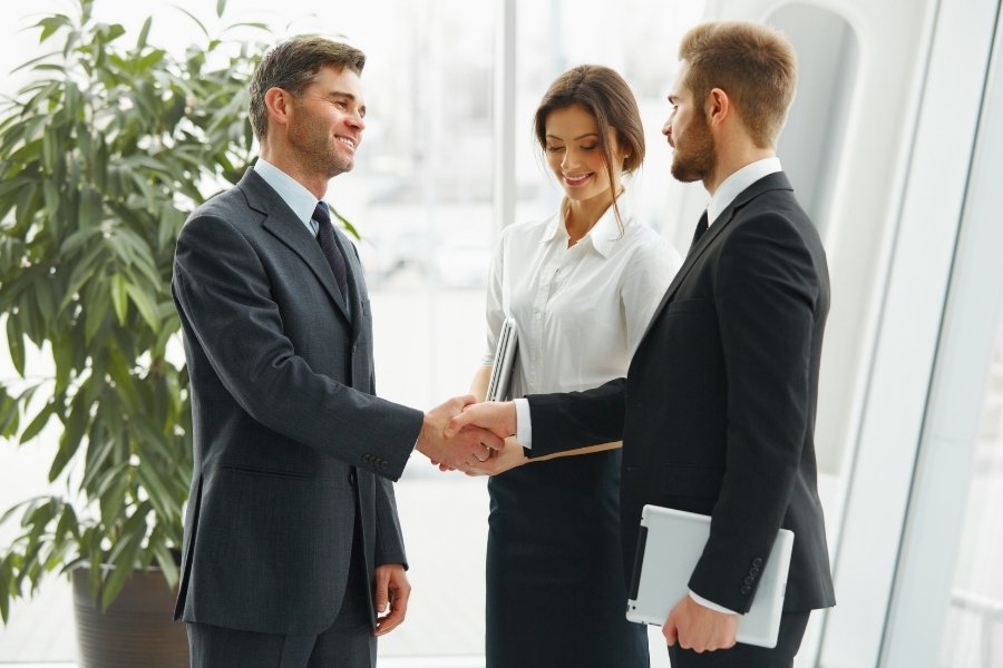 two guys shaking hands to settle a case